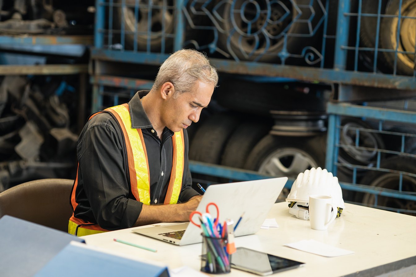 Professional Engineer Foreman Working Intense at Desk Seriously Look